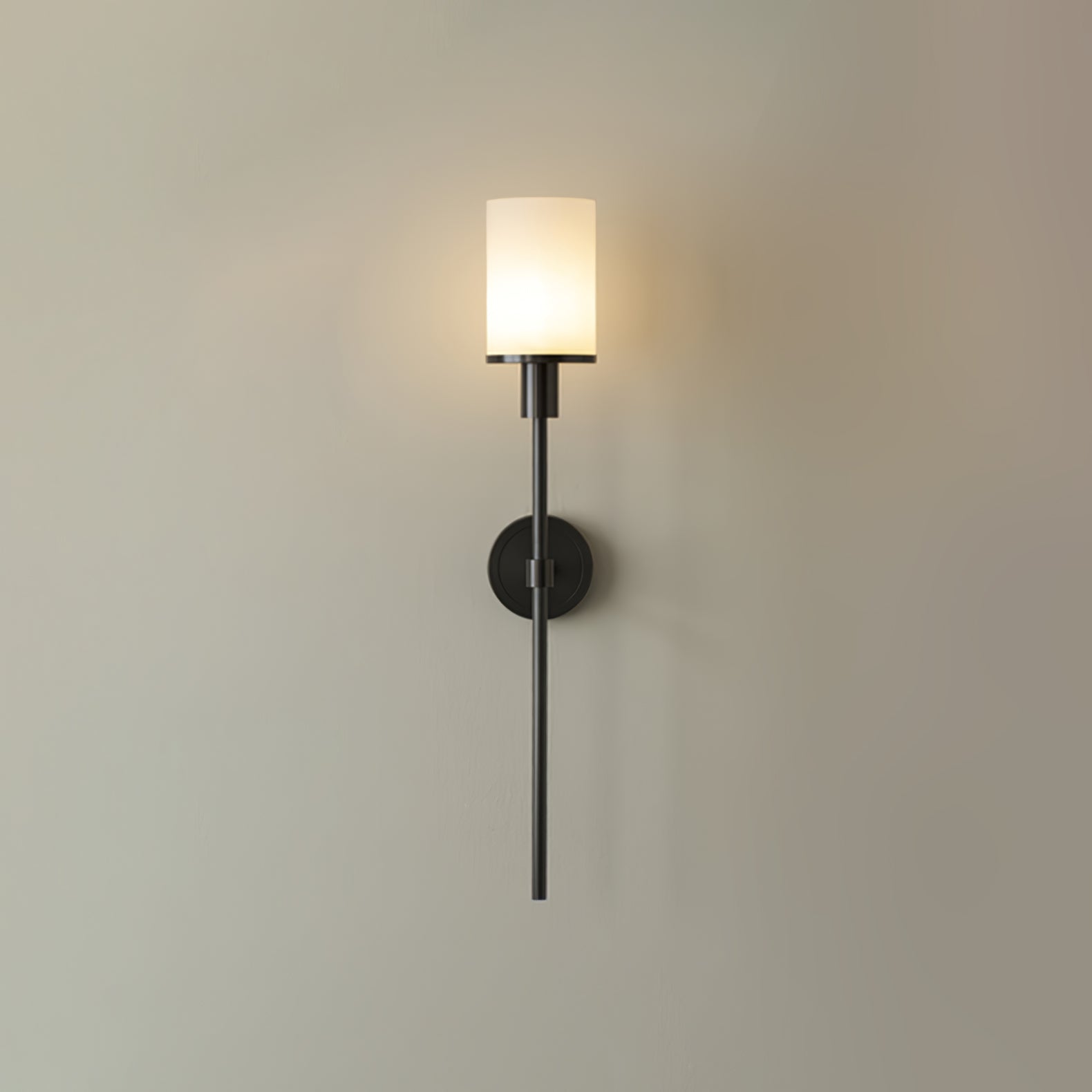 The Clérachic black-finish alabaster sconce seen head-on, its long slim rod running past the wall plate