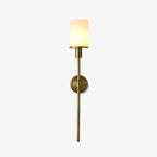 Clérachic brass alabaster wall sconce on a plain white background, whole fixture lit and shown end to end