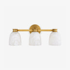 Studio shot of this Clérachic bar sconce in brass finish, three dome alabaster shades on a slim horizontal bar.