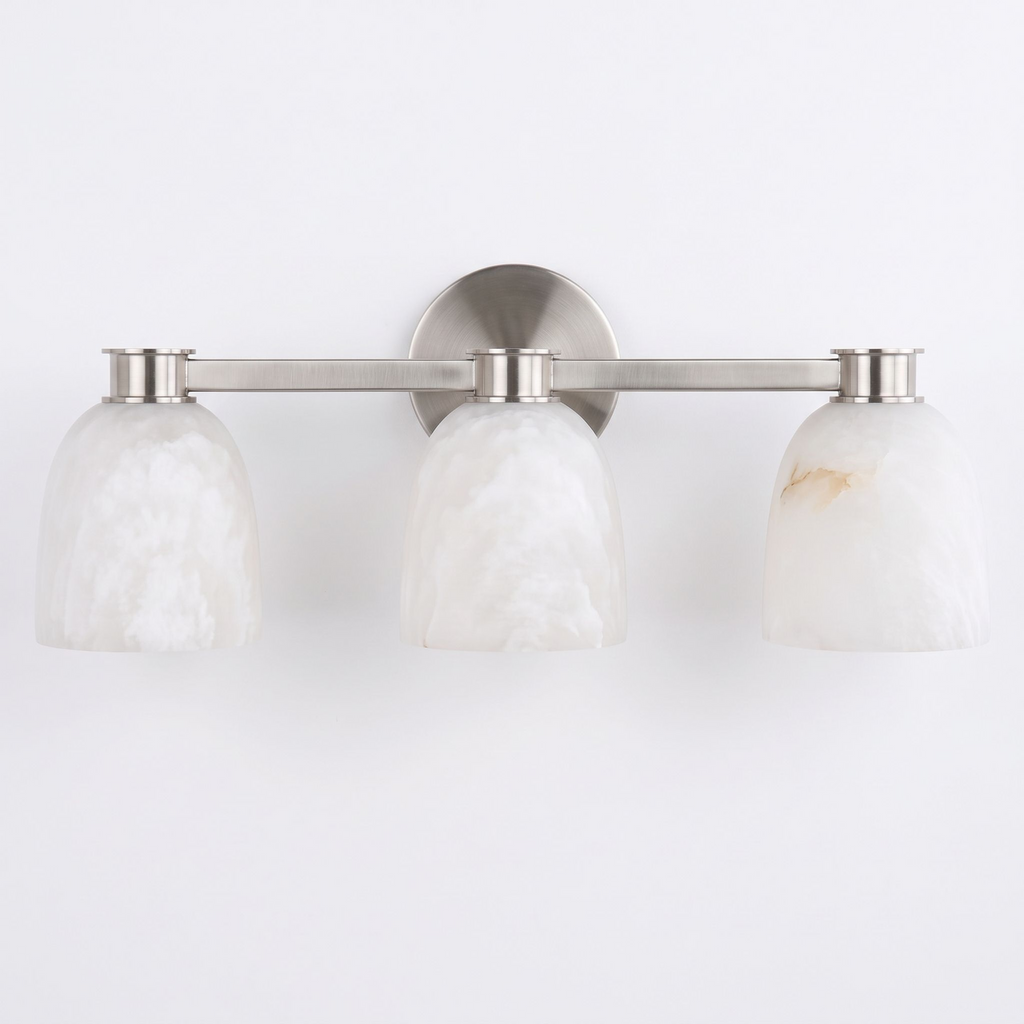 Studio shot of this Clérachic bar sconce in satin nickel finish, three dome alabaster shades set along its bar.