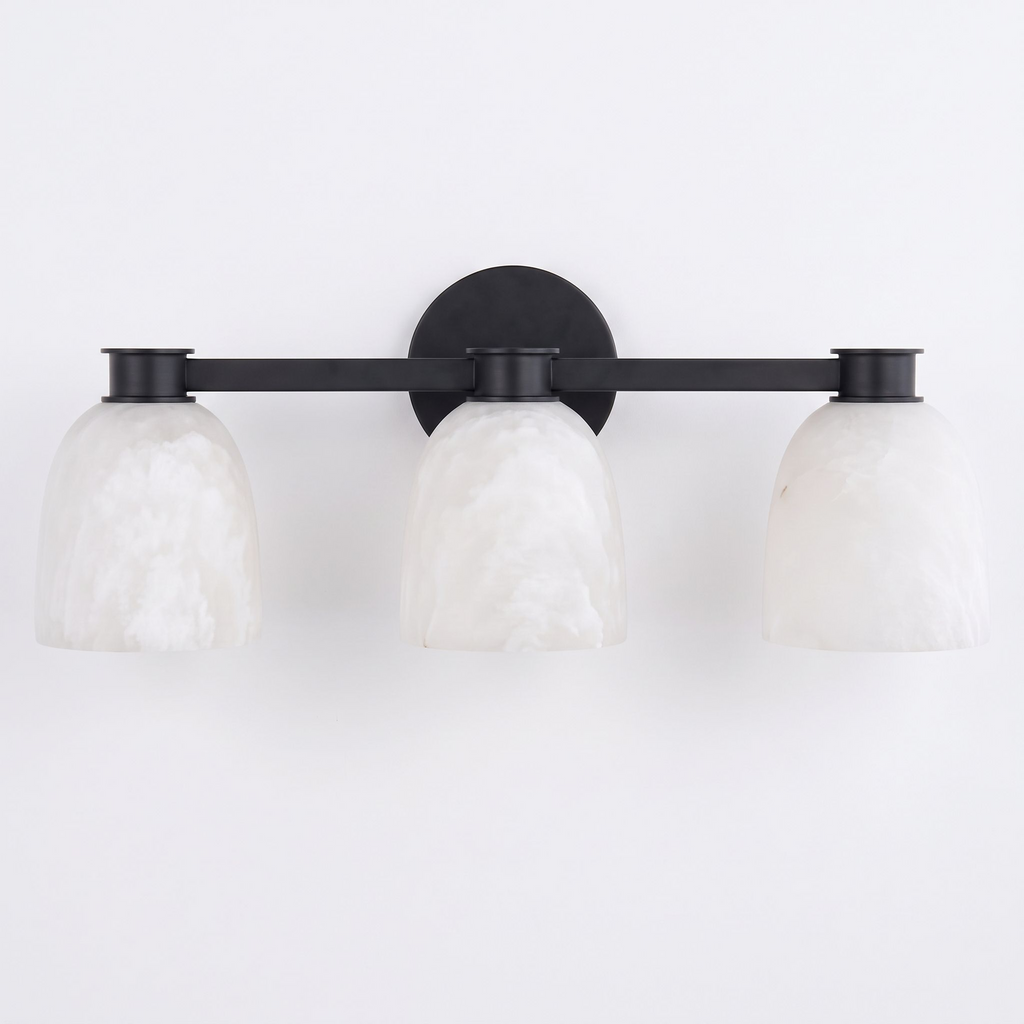 Studio shot of this Clérachic bar sconce in black finish, its three dome shades mounted on a slim bar.