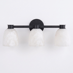 Studio shot of this Clérachic bar sconce in black finish, its three dome shades mounted on a slim bar.