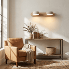 Travertine duo wall light shown lit in a calm modern room