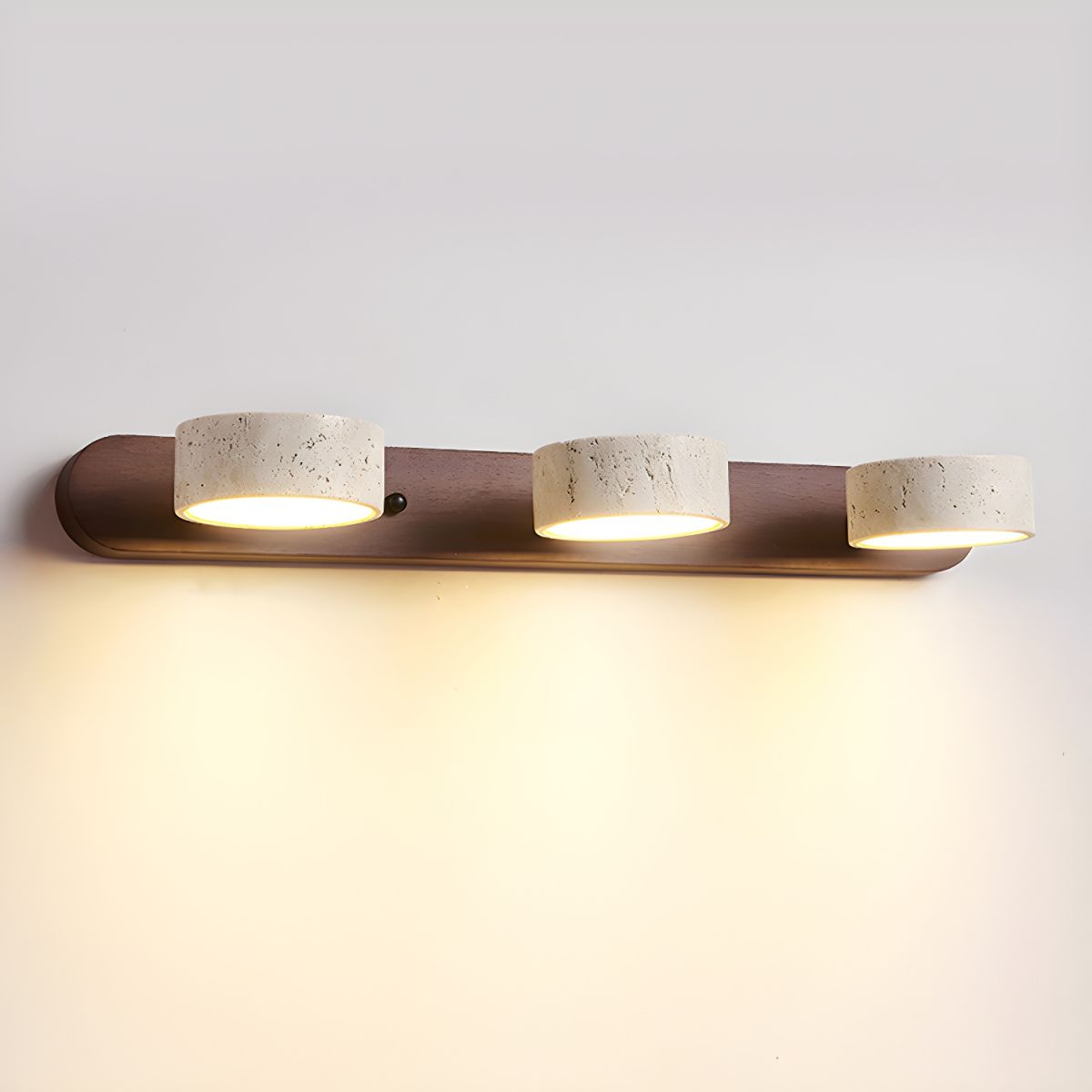 Natural stone wall light casting a warm glow in a bedroom