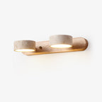 Travertine wall light shown with two natural stone shades lit