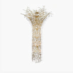 Brass branch chandelier on a white background, clear crystal drops falling from the spreading crown into a long column.