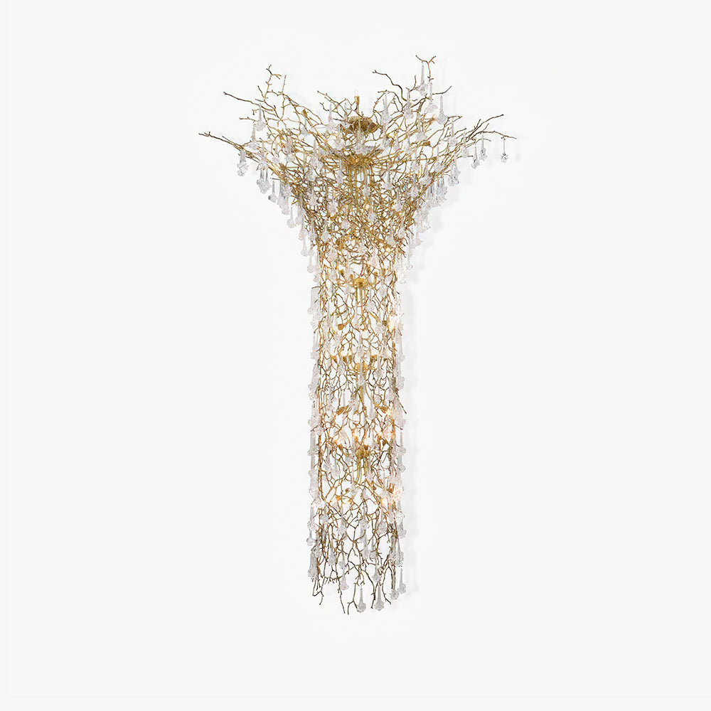 Brass branch chandelier on a white background, clear crystal drops falling from the spreading crown into a long column.
