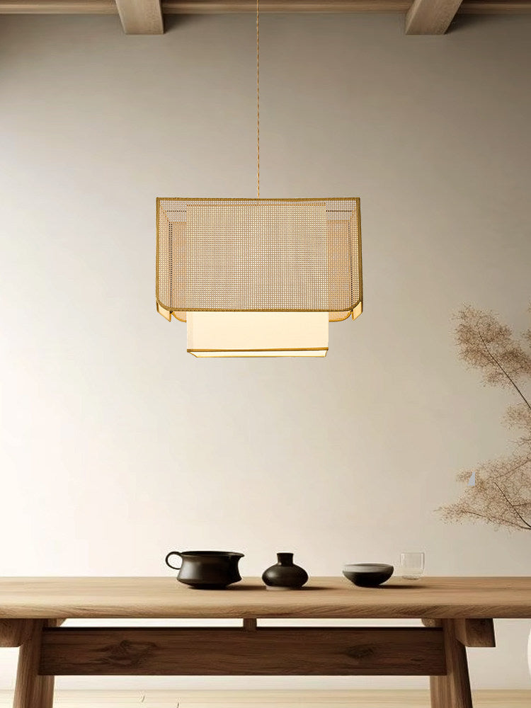 Under an exposed beam ceiling, this Clérachic pendant glows above a wood table set with a teapot and cups.