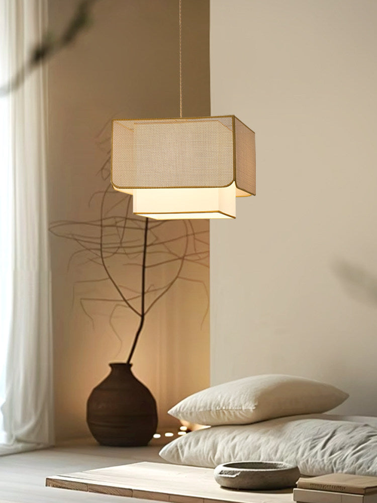 In a low-lit corner with floor cushions and a branch in a vase, this Clérachic pendant glows softly overhead.