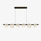 The black-framed chandelier on pale grey, showing the drop cables and rectangular ceiling plate.