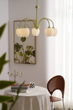 Matcha green tulip chandelier lit in a styled room