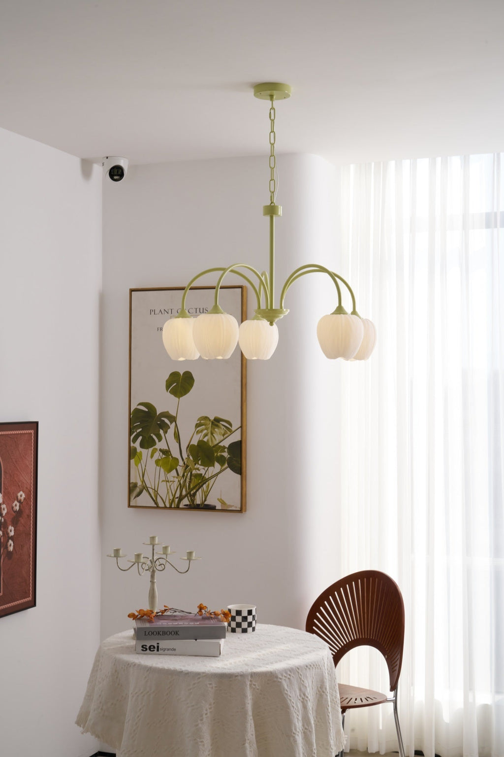 Matcha green tulip chandelier with white glass shades lit