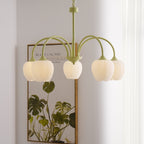 Tulip chandelier glowing warm above a living space