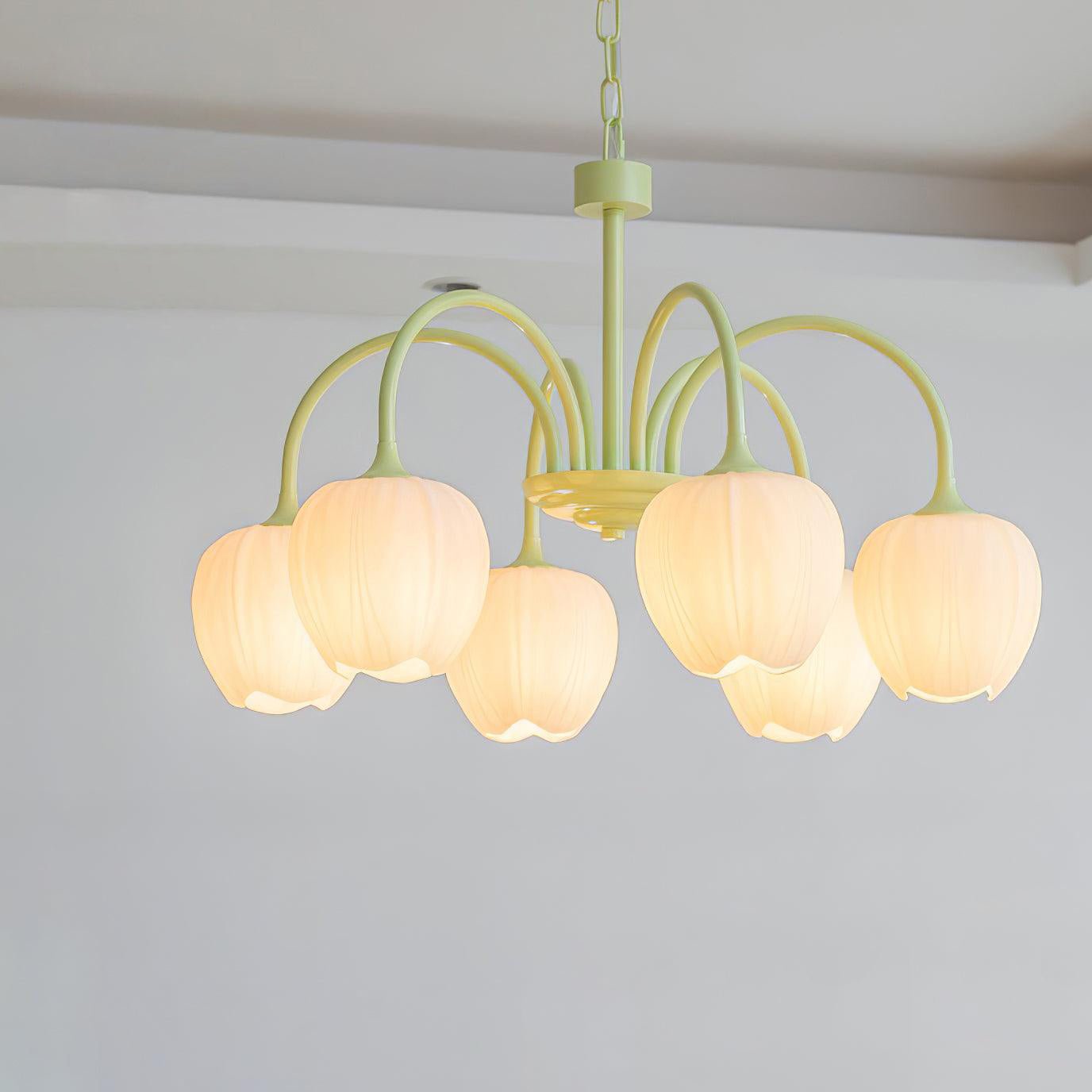 Matcha green chandelier with white tulip glass shades glowing