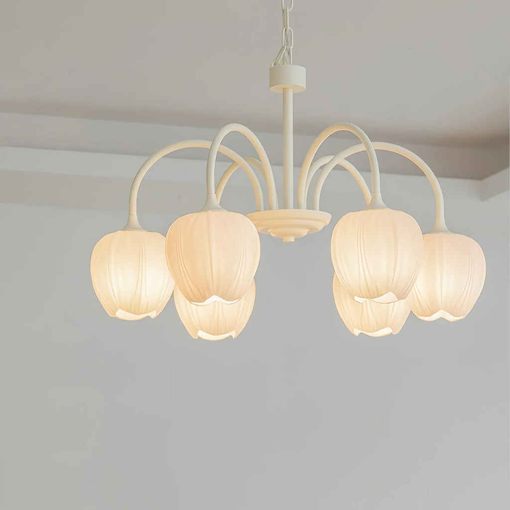 Tulip chandelier with botanical glass shades lit warm