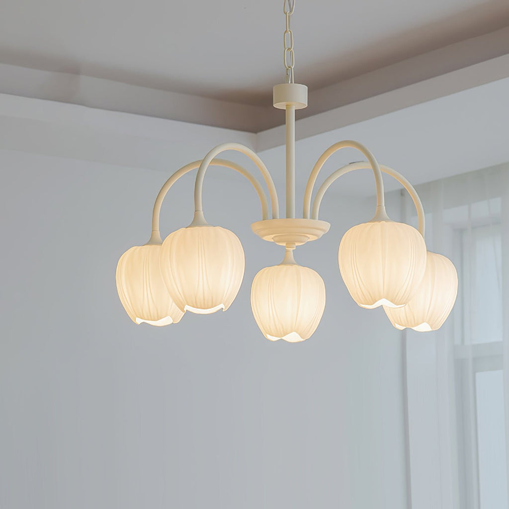 White glass tulip shades on a matcha green chandelier frame