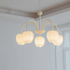 White glass tulip shades on a matcha green chandelier frame