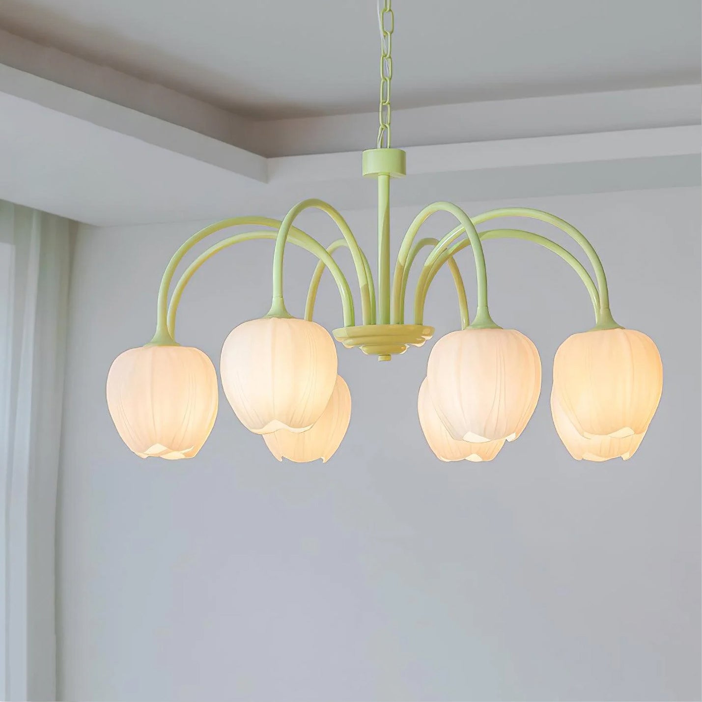 Tulip chandelier glowing softly above a dining setting