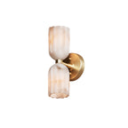 Brass double alabaster wall sconce on a plain white background, angled to show the round backplate