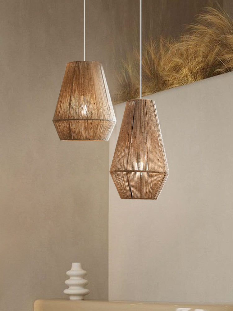 Against a plain wall beside dried pampas grass, two jute rope Clérachic pendants pair bowl-cone and teardrop shades.