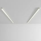 Two white Clérachic ceiling lights angle apart, glowing warmly against a plain grey backdrop.