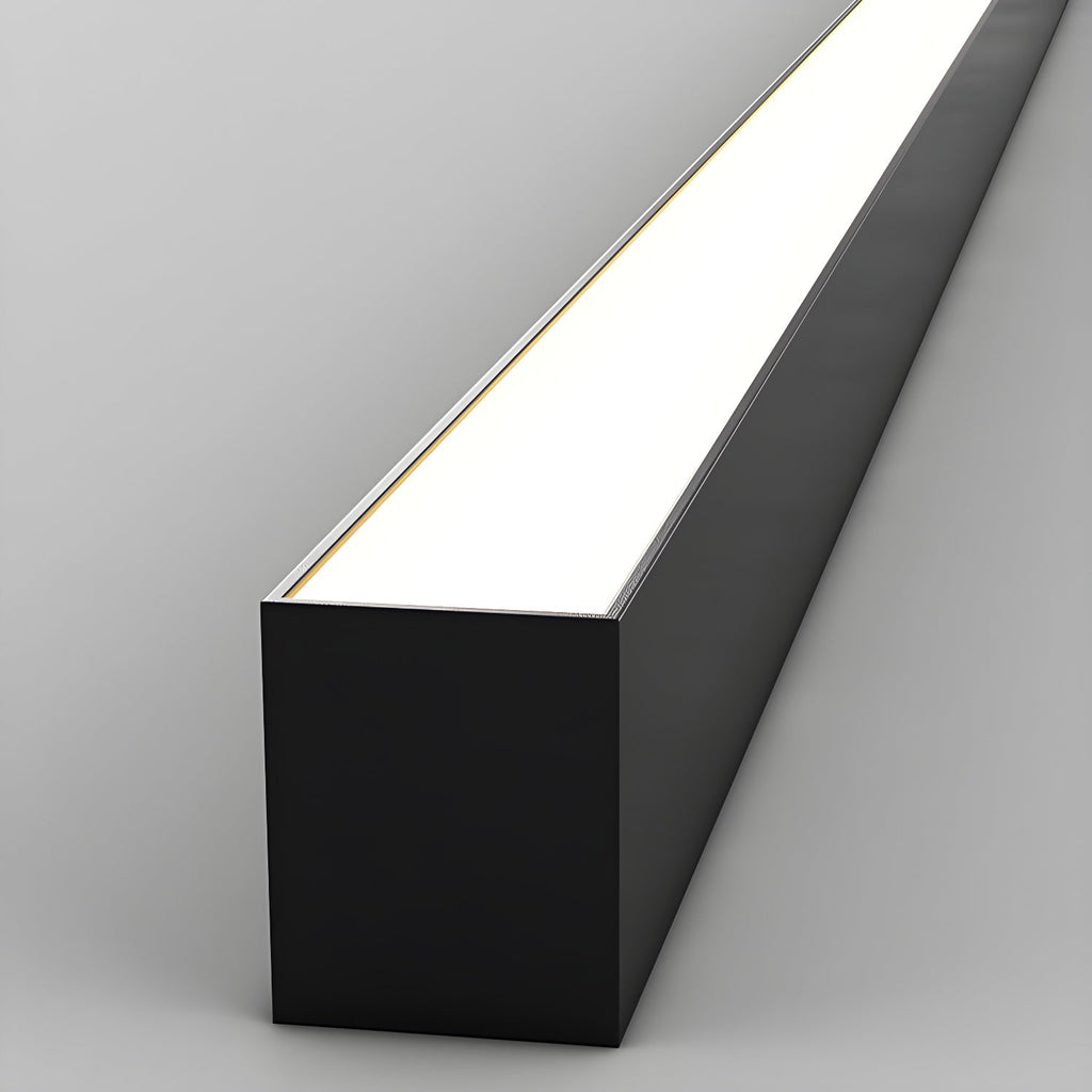 Close view of this Clérachic ceiling light's black profile, its diffuser glowing brightly along its length.