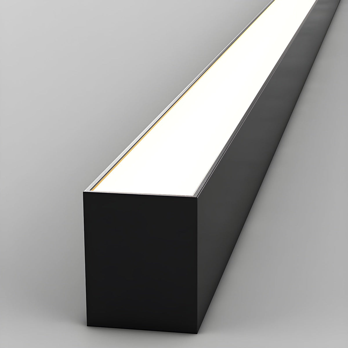Close view of this Clérachic ceiling light's black profile, its diffuser glowing brightly along its length.