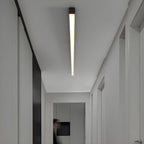 This Clérachic ceiling light casts a warm glow down a narrow hallway lined with closed doors.
