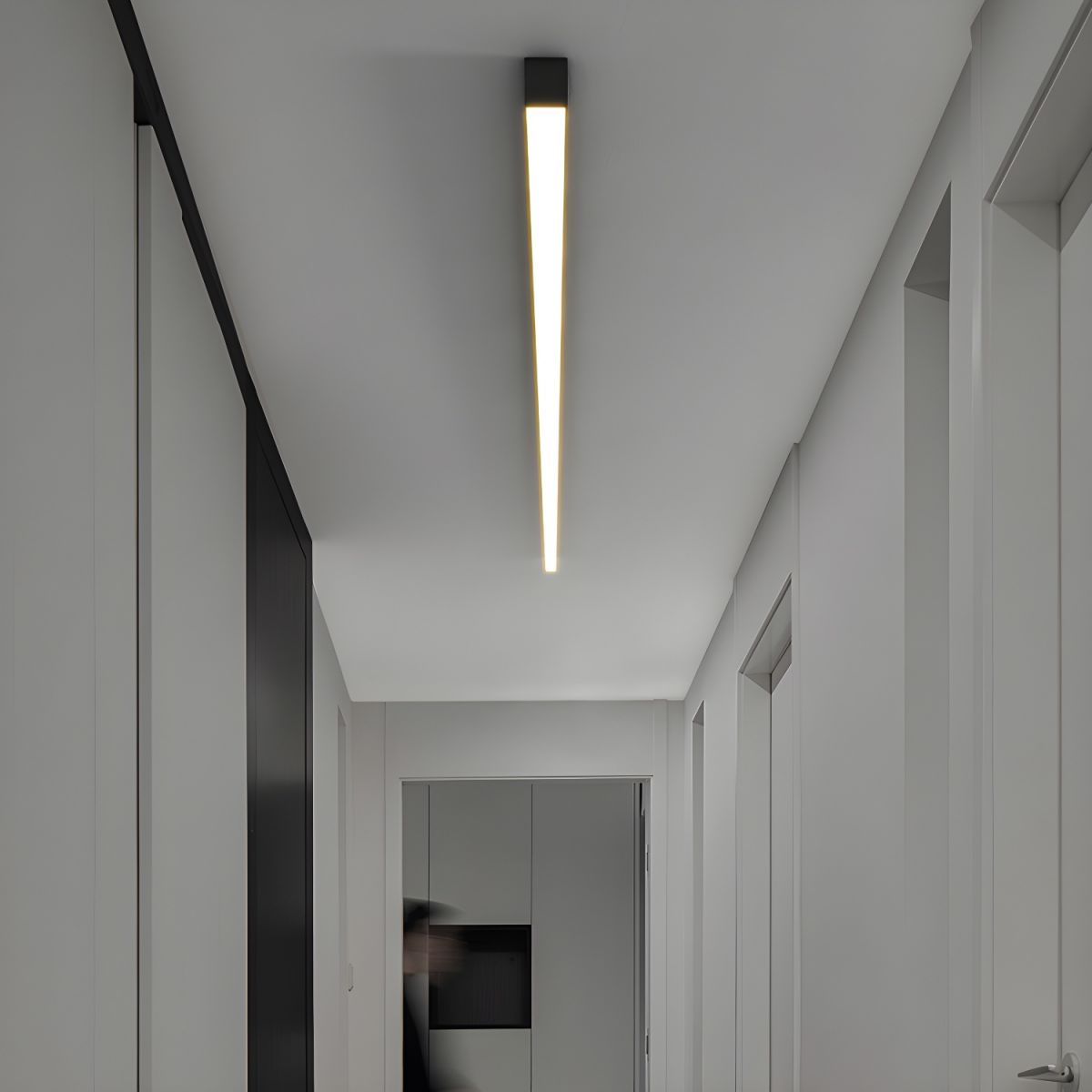 This Clérachic ceiling light casts a warm glow down a narrow hallway lined with closed doors.