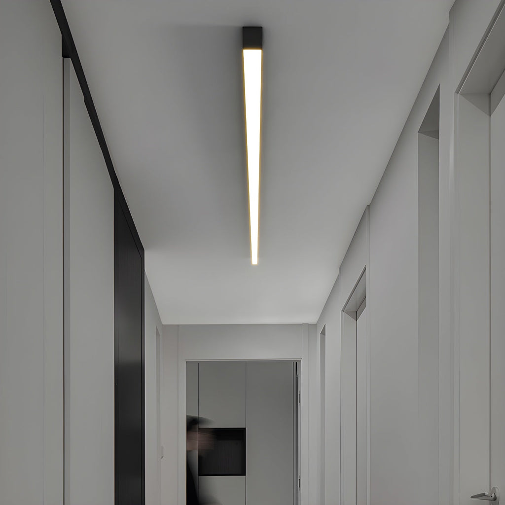 This Clérachic ceiling light glows warmly along a hallway ceiling, seen from a slightly different angle.