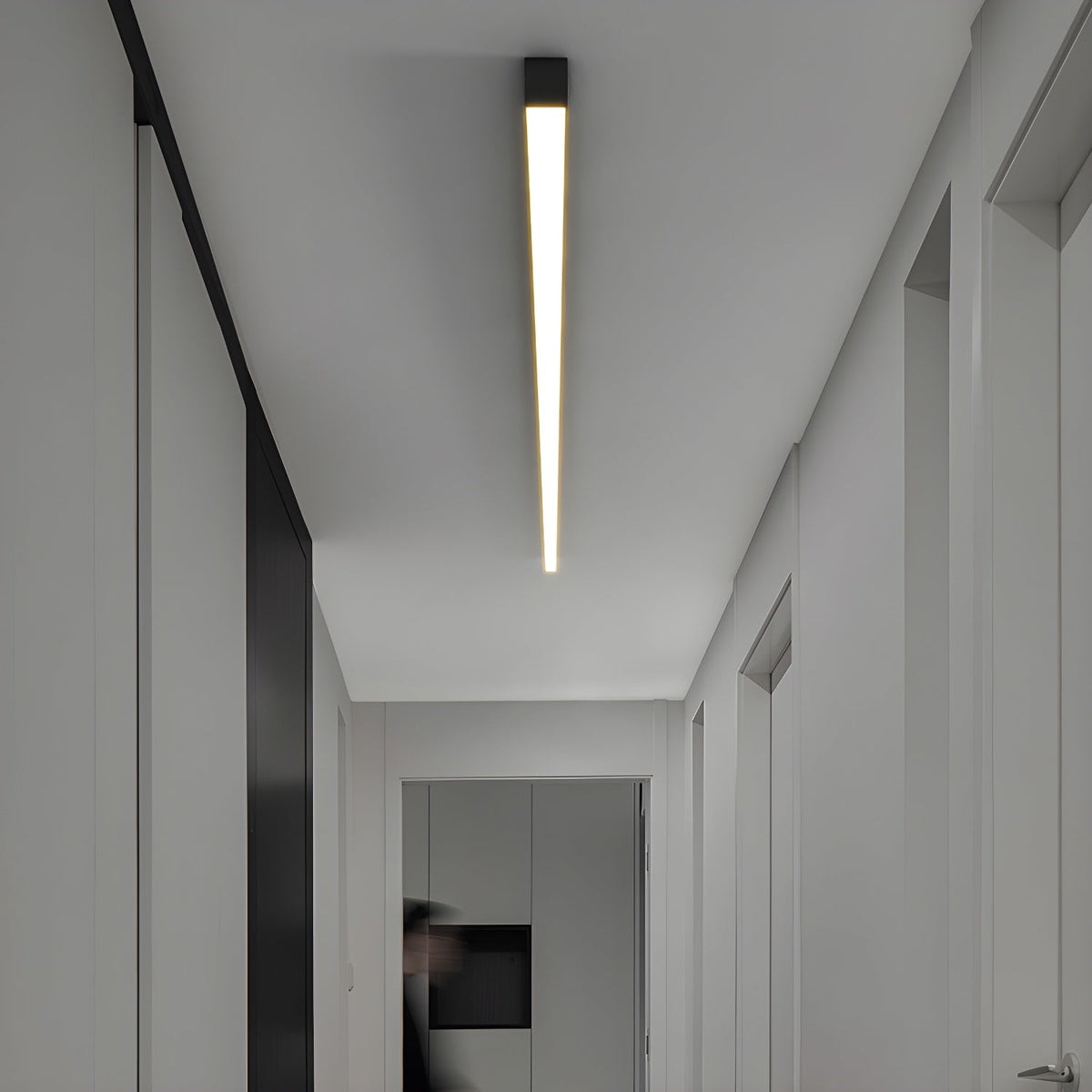 This Clérachic ceiling light glows warmly along a hallway ceiling, seen from a slightly different angle.