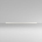 This Clérachic ceiling light in white lies flat and unlit, its slim profile catching light on a plain grey backdrop.