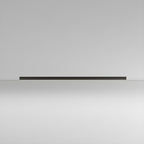 This Clérachic ceiling light in black lies flat and unlit, its slim profile visible against a plain grey backdrop.
