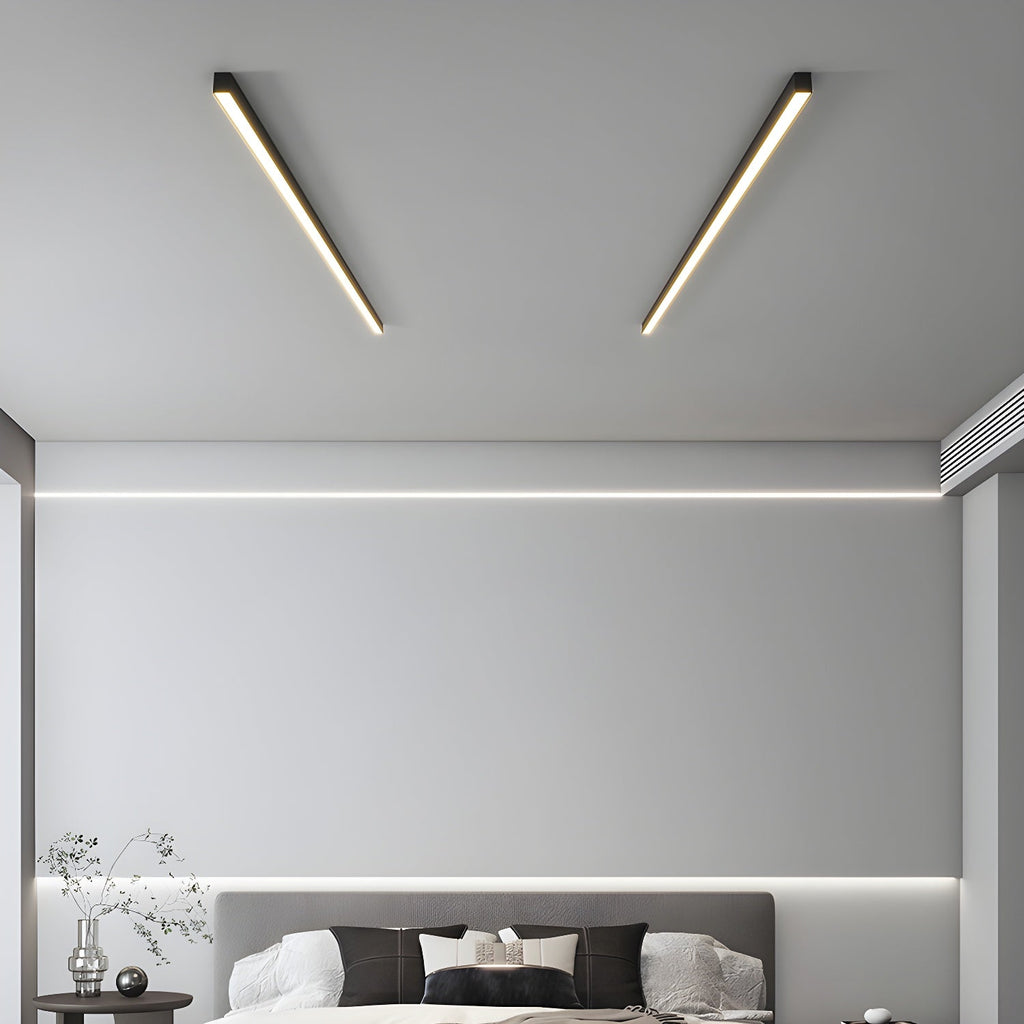 Two black Clérachic ceiling lights angle across a bedroom ceiling above a grey upholstered bed.