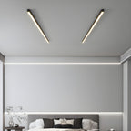 Two black Clérachic ceiling lights angle across a bedroom ceiling above a grey upholstered bed.