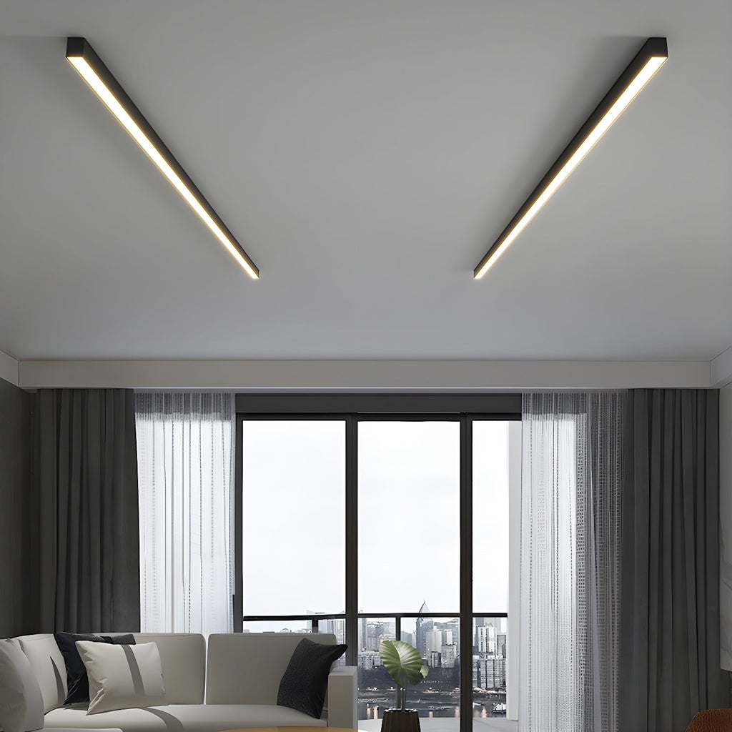 Two black Clérachic ceiling lights run flush across a living-room ceiling, above sheer curtains and floor-to-ceiling windows.