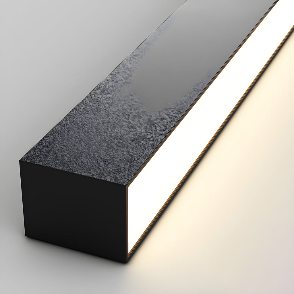 Close view of this Clérachic ceiling light's black corner profile, its diffuser glowing warmly along one edge.