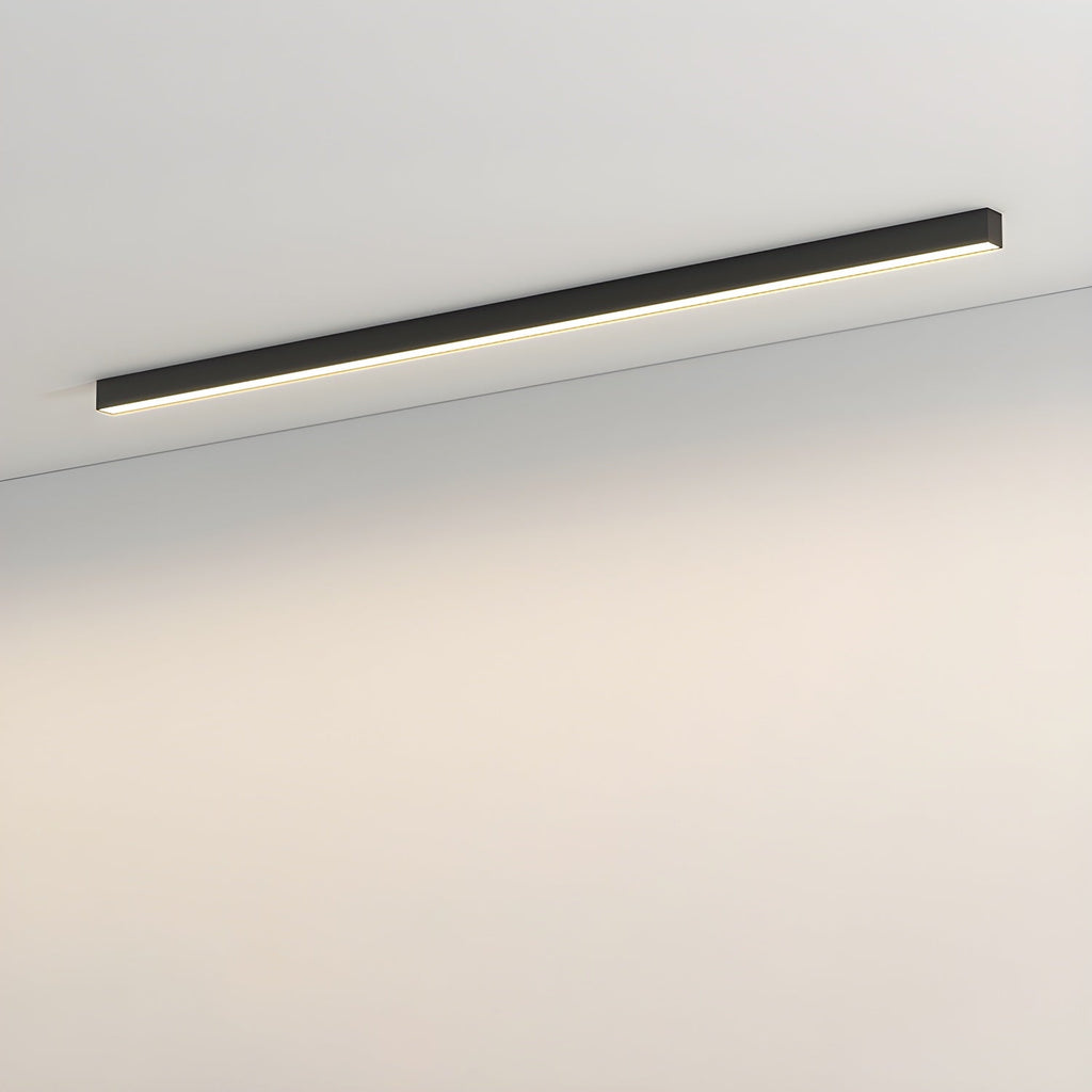 This Clérachic ceiling light, a slim black bar, sits unlit against a plain wall and ceiling corner.