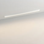 This Clérachic ceiling light in white runs along a plain wall, its diffuser glowing with a warm light.