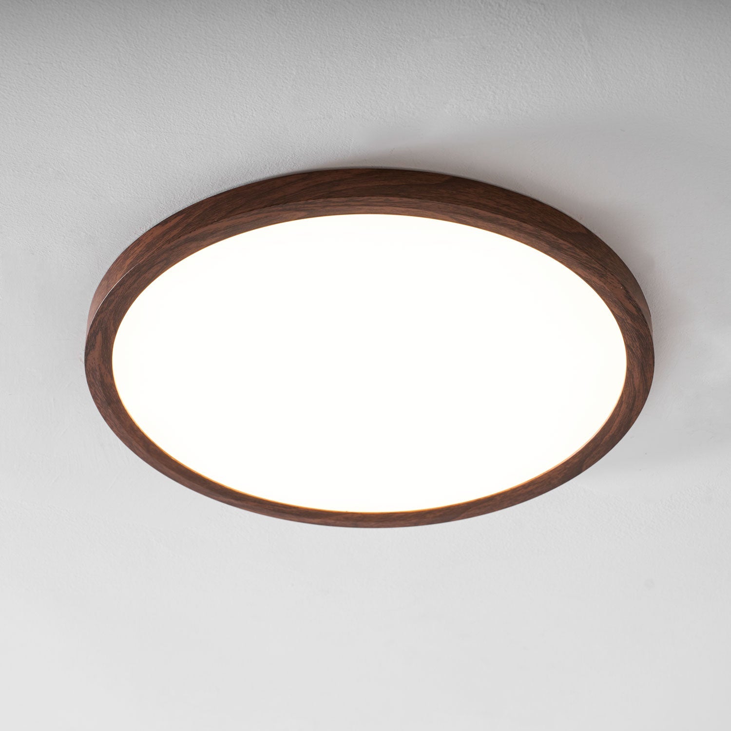 Ultra-slim ceiling light in walnut finish seen at an angle