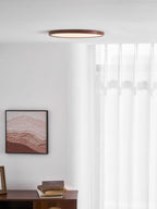 Walnut wood-grain ceiling light glowing warm in a bedroom setting