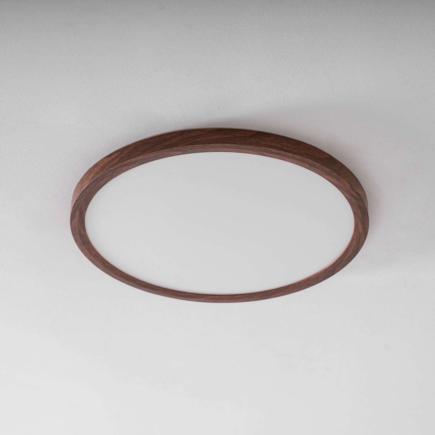 Walnut wood-grain ceiling light casting an even overhead glow
