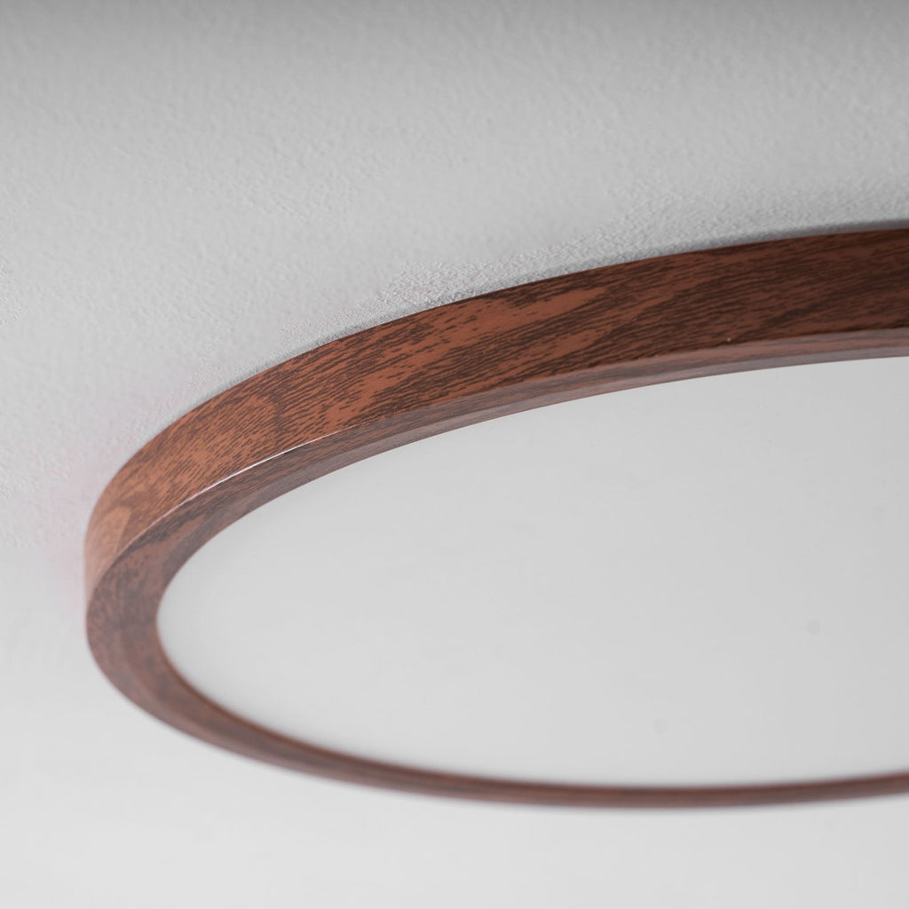 Ultra-thin round ceiling light in walnut finish lighting a room