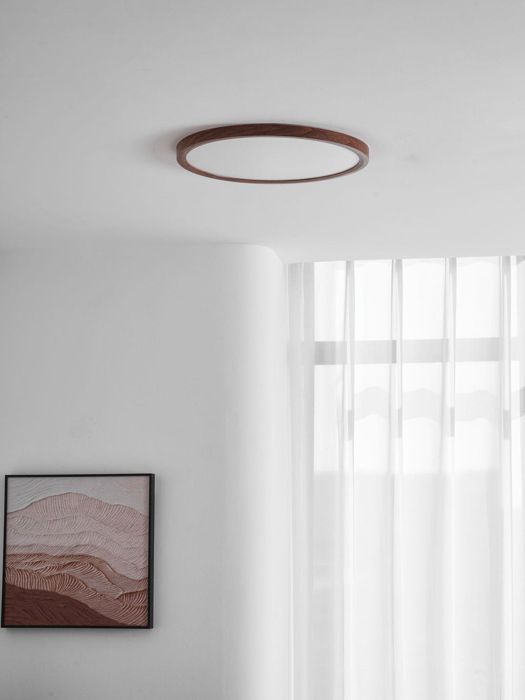 Round ceiling light with walnut finish illuminating a living space