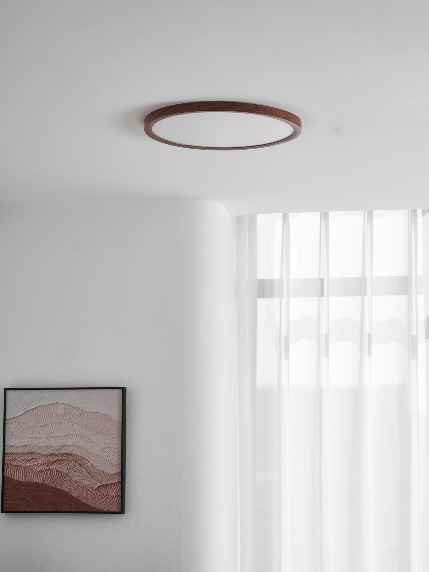 Round ceiling light with walnut finish illuminating a living space