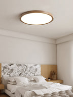 Round ceiling light showing slim profile and warm walnut frame