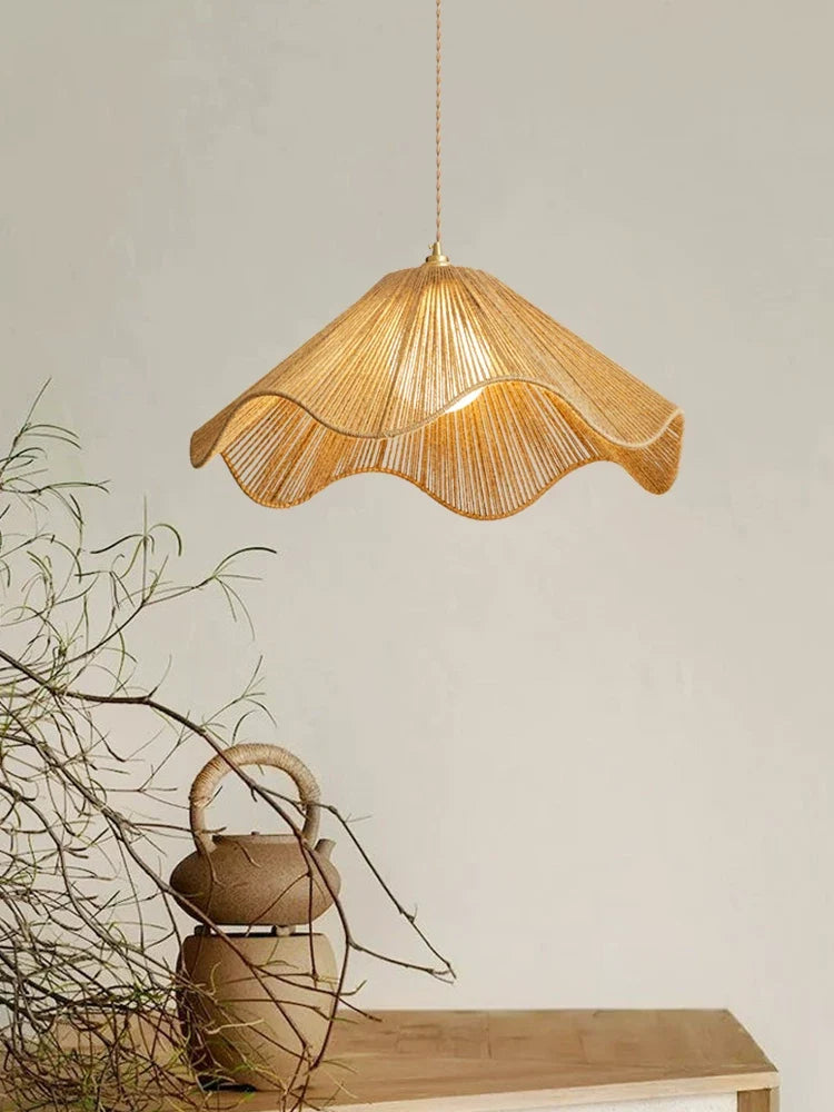 Near dried branches and a small rope-handled jug, this Clérachic pendant's radially woven hemp-rope shade glows warm.