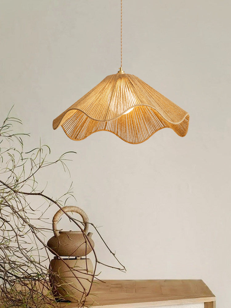 Dried branches and a woven rope jug sit below this lit Clérachic pendant's flared hemp-rope shade.