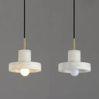 Two Ritta hat-shaped pendants side by side, one switched on and one off, against grey.