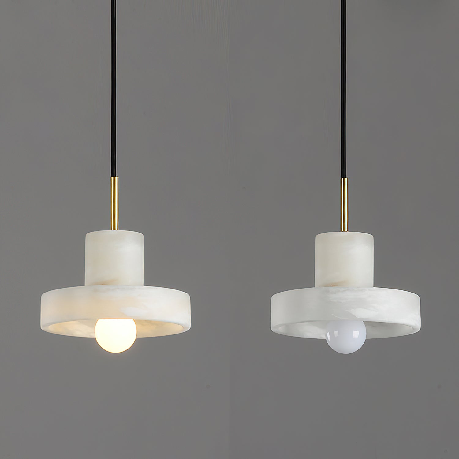 Two Ritta hat-shaped pendants side by side, one switched on and one off, against grey.